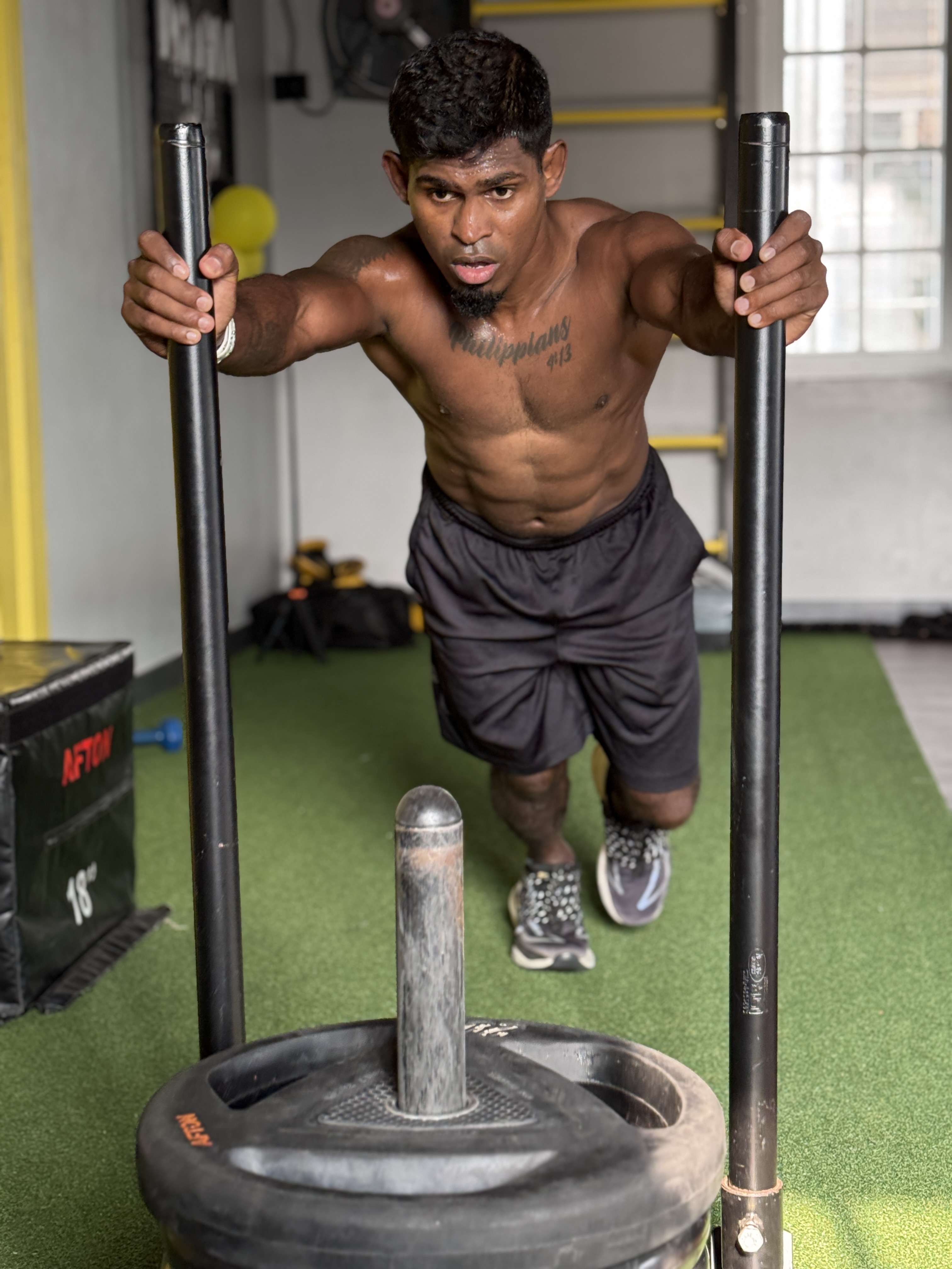 Coach Mathi training with sled push exercise